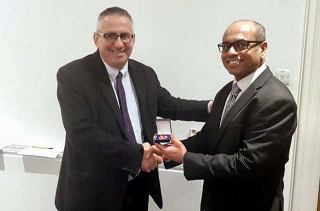 Laurence Lee (left) receives his award from Professor Frank Joseph...